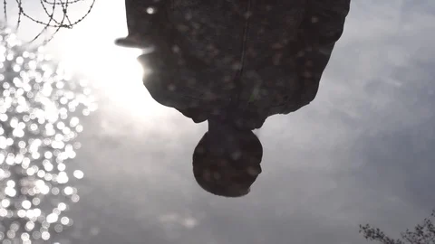 A person's reflection in the water on the pavement. Stock Footage 129792077