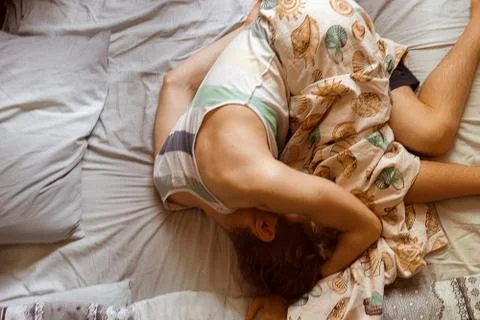 Person's wrong position during the sleep in bed, bad postures Stock-Fotos