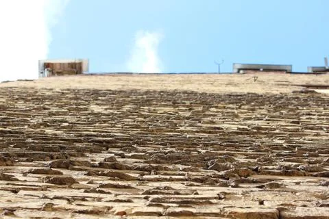 The perspective of a brick beige wall, between the bricks Foto stock