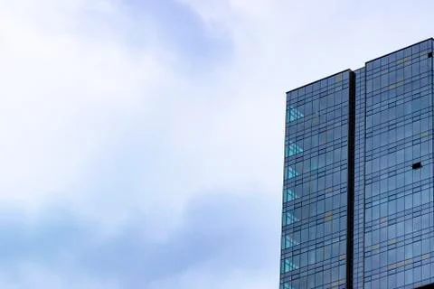 Perspective of clear blue colored high-rise building with glass facade Stock Photos