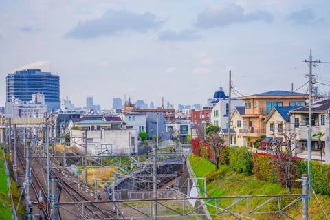 A perspective composition of multiple train tracks passing through Jiyugaoka. Stock Photos