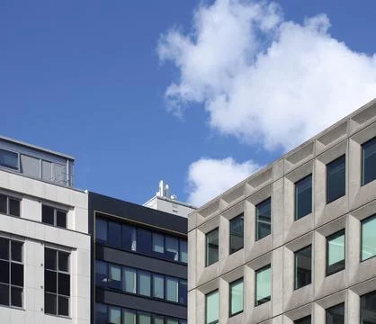 Perspective corner view of a group of modern office buildings against a blue sky Fotos de archivo