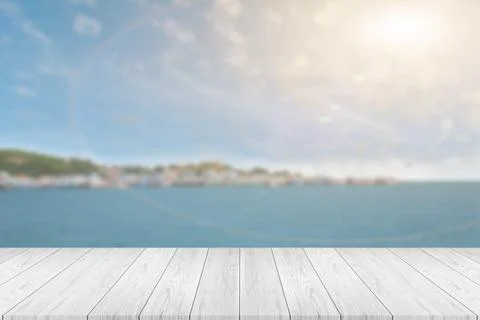 Perspective empty white wooden table on top over blur seascape background. Fo Stock Photos