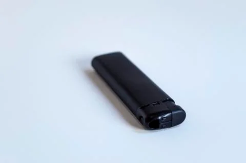 Perspective front shoot of horizontal full black lighter on white surface Stock Photos