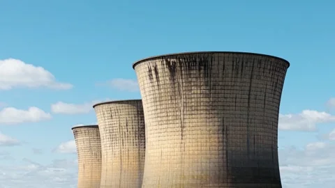 Perspective line of nuclear cooling towers forming repeating industrial pattern Stock Footage 334324130