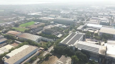 Perspective looking over a sprawling industrial city during a hazy morning Stock Footage 332068538