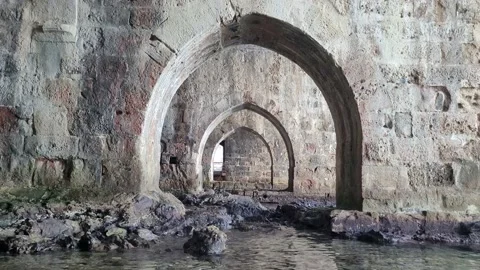 Perspective of the old shipyard through stone arches in Turkish Alanya Stock Footage 197740711
