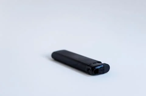 Perspective open shoot of horizontal black lighter on white surface Stock Photos