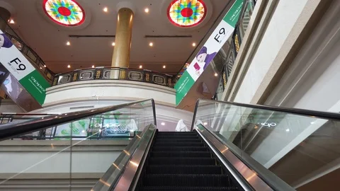 Perspective of person on a moving escalator going up inside a shopping mall. Stock Footage 105401633