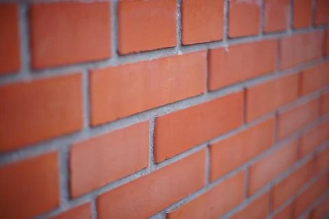 Perspective of a red brick wall, selective focus. Фото