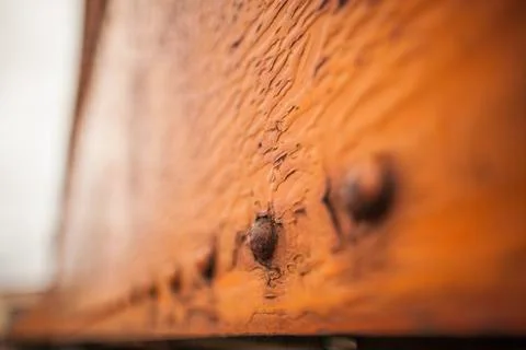 Perspective of Rusty Brown Boxcar With Rivets and Chipping Paint Stock Photos
