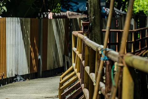 Perspective of rusty iron railing on canal walkway near midnight Fotos de archivo