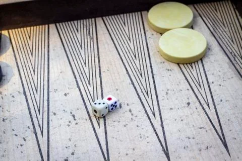 Perspective shoot of dices on backgammon under open light with play stones Stock Photos