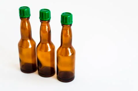Perspective up shoot of three small alcohol bottles brown colored Stock Photos