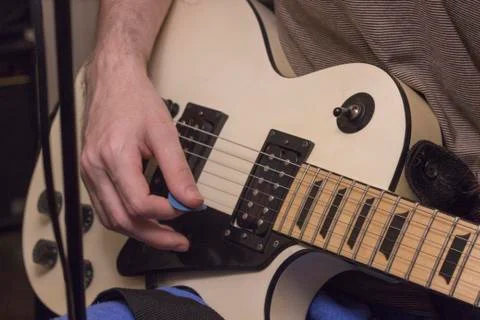 Perspective shot guitar practice under the dim light Foto stock