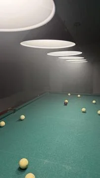 A perspective shot looking down a green billiards table with white balls Stock Photos