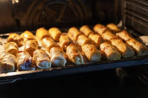 A perspective shot of several rows of golden-brown crepe rolls (nalysnyky) wi Stock Photos