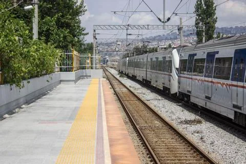 Perspective shot of train station that there is passing train at suburban are Stock Photos