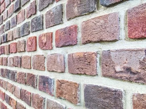 Perspective side view of old red brick wall. Red brick wall Foto stock