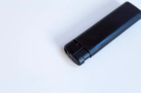Perspective top shoot of angled full black lighter on white surface Stock Photos