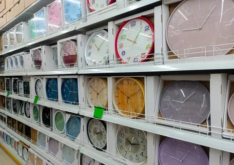 Perspective View Of An Arrangement Of Various Wall Clocks On A Shelf Stock Photos