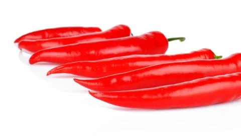 Perspective view of chilli red peppers isolated on white background Stock Photos