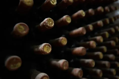 Perspective view closeup of stacked aged wine bottles Stock Photos