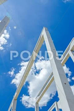 Perspective view of concrete pillars, edifice in progress of growing into tal Stock Photos