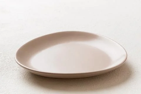 Perspective view of empty light plate on wooden background. Empty space for y Stock Photos