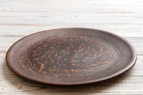 Perspective view of empty plate on wooden background. Empty space for your .. Stock Photos