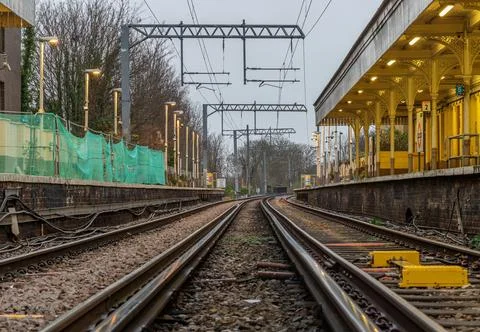 Perspective view on empty railway tracks and electric infrastructure equipm.. Stock Photos