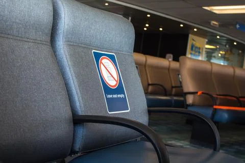 Perspective view of empty seats in the airport with social distancing regulat Stock Photos