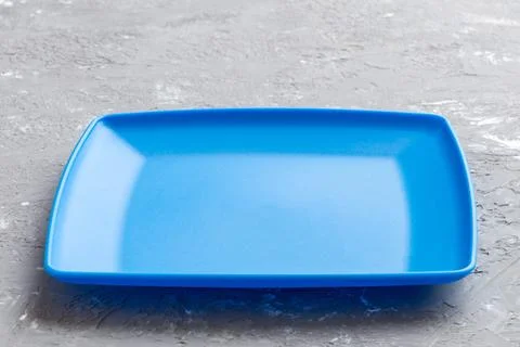 Perspective view of empty square plate on cement background. Empty space fo.. Stock Photos