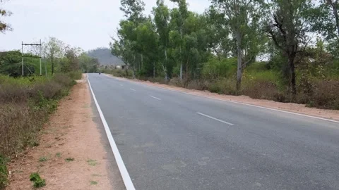 Perspective view of an empty two-lane asphalt highway Stock Footage 329541748