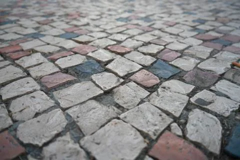 Perspective view floating over cobblestone tiles in the cloudy day Stock Photos