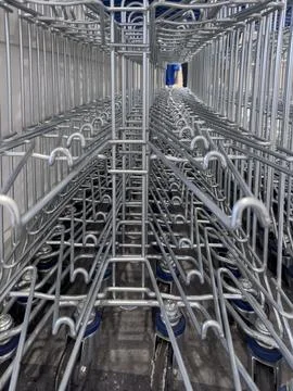 Perspective view inside nested shopping carts showing metal structure pattern Stock Photos
