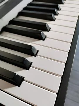 A perspective view of a keyboard with black and white keys Stock Photos
