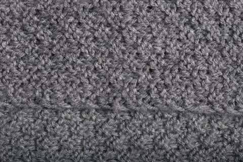 Perspective view of knitted gray wool fabric, textile background. Stock Photos