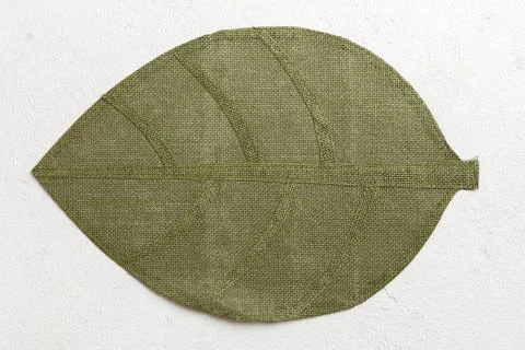 Perspective view of leaf shaped tablecloth for food on cement background. Emp Stock Photos