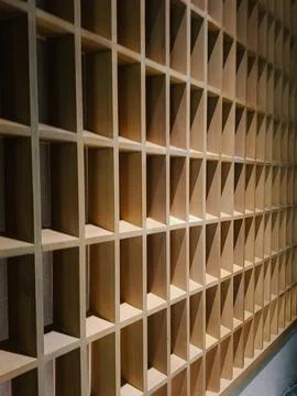 Perspective view of a light-colored wooden lattice wall partition with squa.. Stock Photos