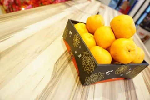 Perspective view of Mandarin oranges or Lokam inside beautiful wooden tray fo Stock Photos