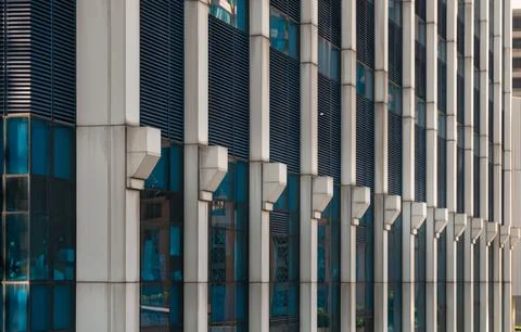 Perspective view of modern building facade with blue sky and clouds reflect.. Stock Photos