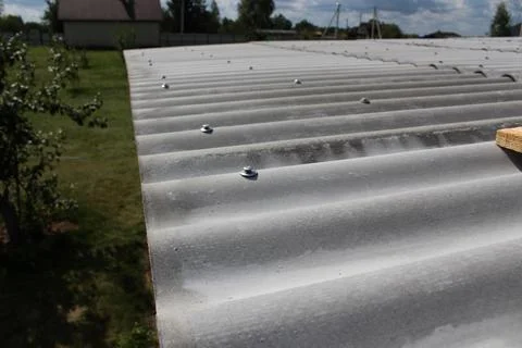 Perspective view of a newly installed corrugated slate roof with rows of me.. Fotos de archivo