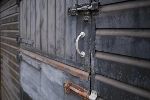 Perspective view of old rusty metal door with locks. Focused in foreground. 写真素材