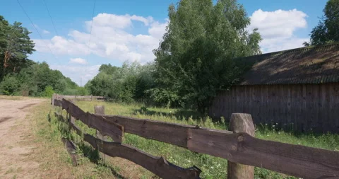 Perspective view at old wooden barn behind a rustic fence in the countryside Stock Footage 340196345