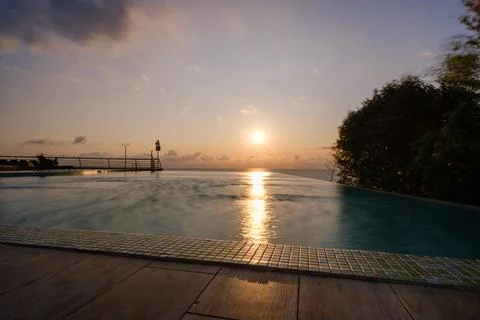 Perspective view of an outdoor infinity swimming pool at sunset Stock Photos