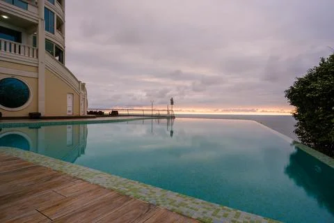 Perspective view of an outdoor infinity swimming pool at sunset Stock Photos