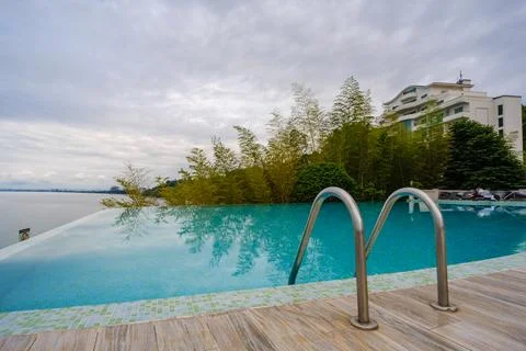 Perspective view of an outdoor infinity swimming pool at sunset Stock Photos