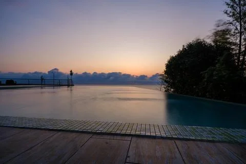 Perspective view of an outdoor infinity swimming pool at sunset Stock Photos