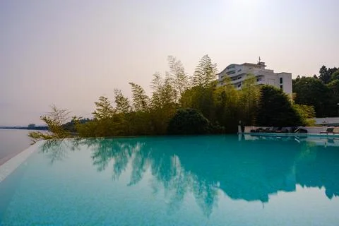 Perspective view of an outdoor infinity swimming pool at sunset Stock Photos